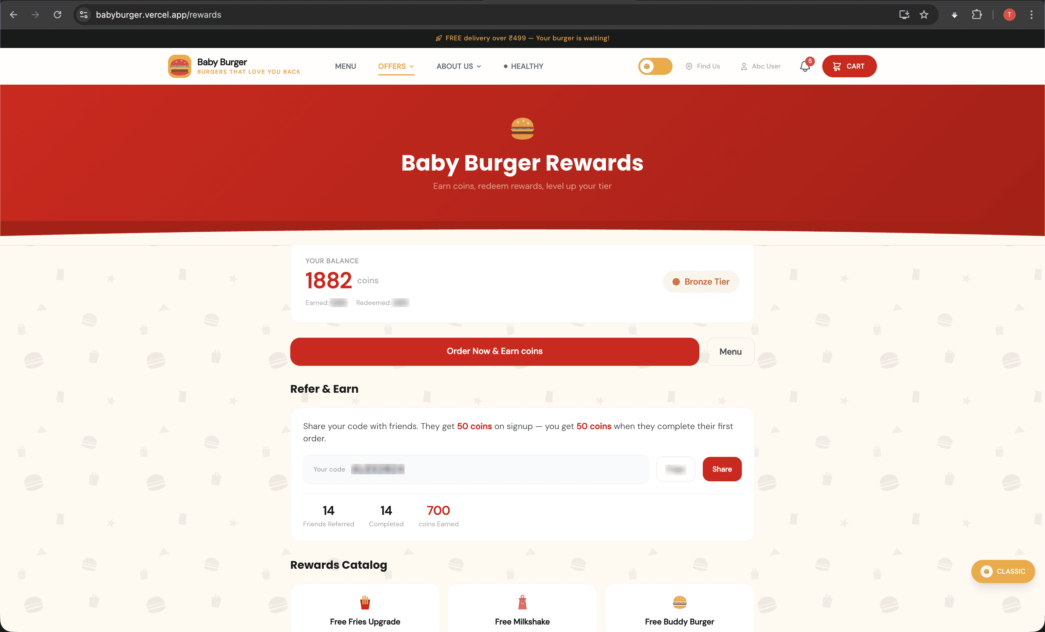 Burger Empire rewards page showing 1882 coins balance, Bronze tier, refer-and-earn program, and rewards catalog